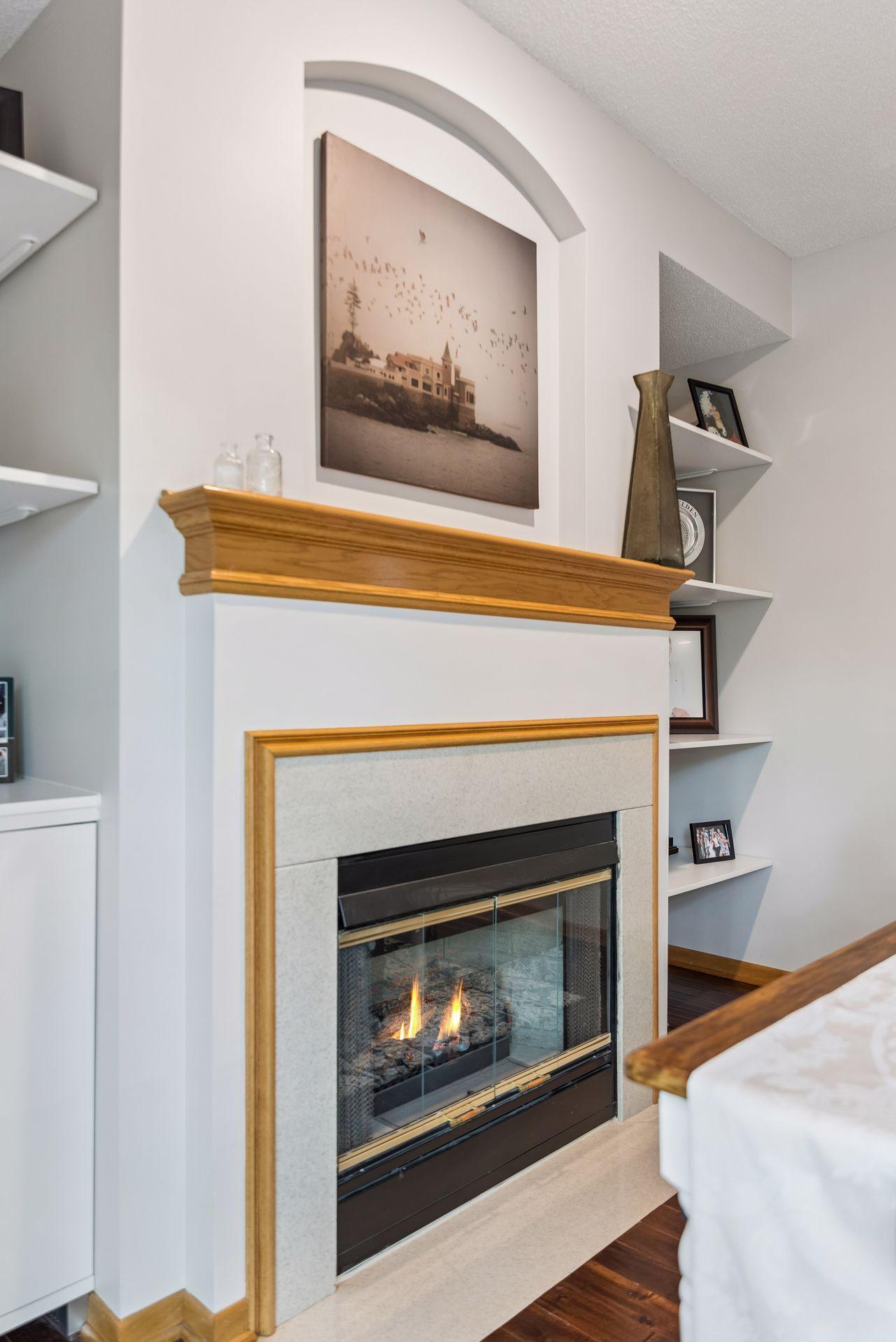 Features a gas fireplace with flanking shelving & cabinets in this dining room.