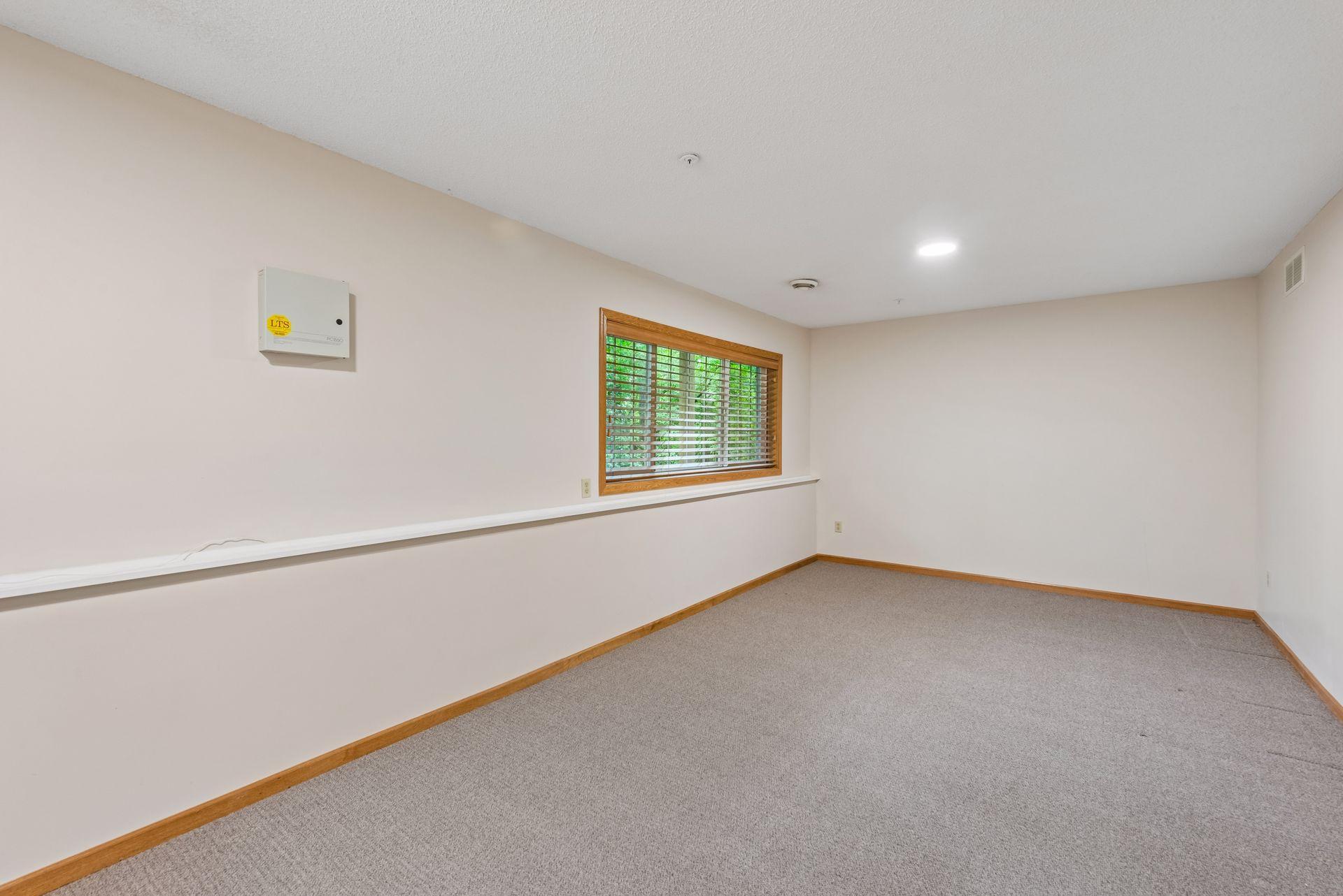A large, finished room with daylight windows on the lower level is perfect for use as a family room, playroom, office, or guest bedroom.