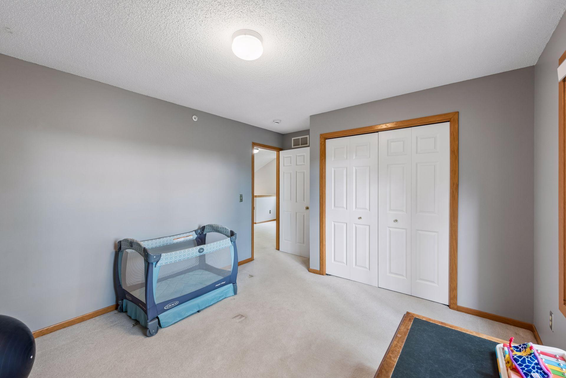 Bedroom 2 - Well-sized and have tree-topped nature views of pond.