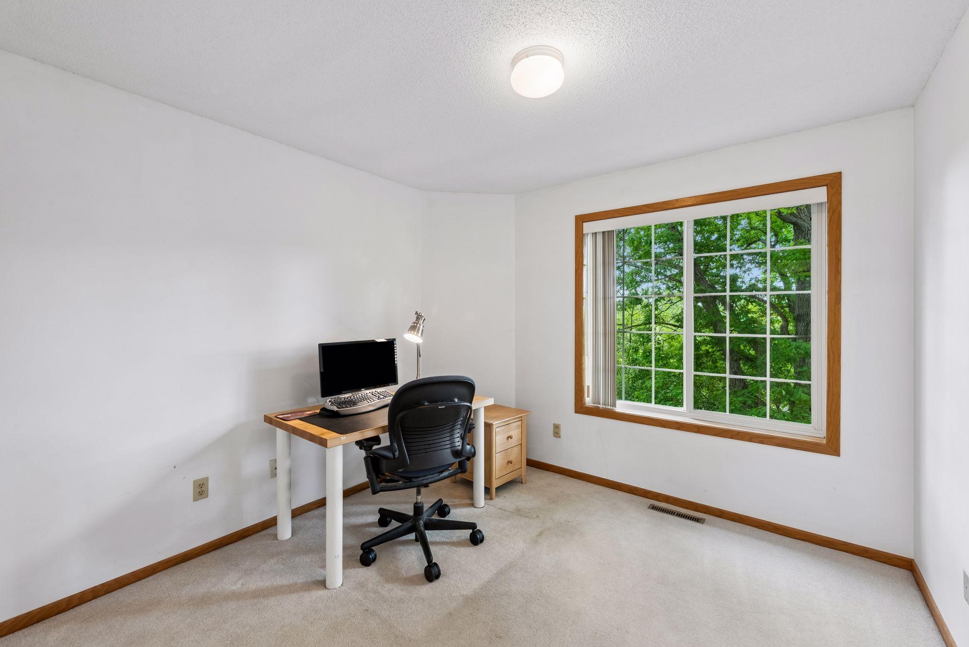 Bedroom 3 - tree-topped nature views of pond.