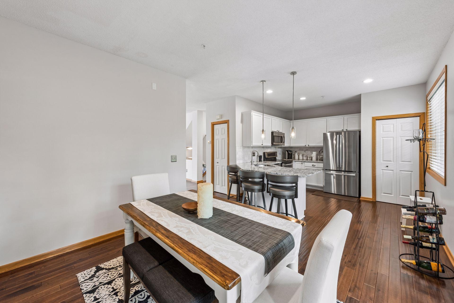 The open concept main floor is updated with dark wood flooring.