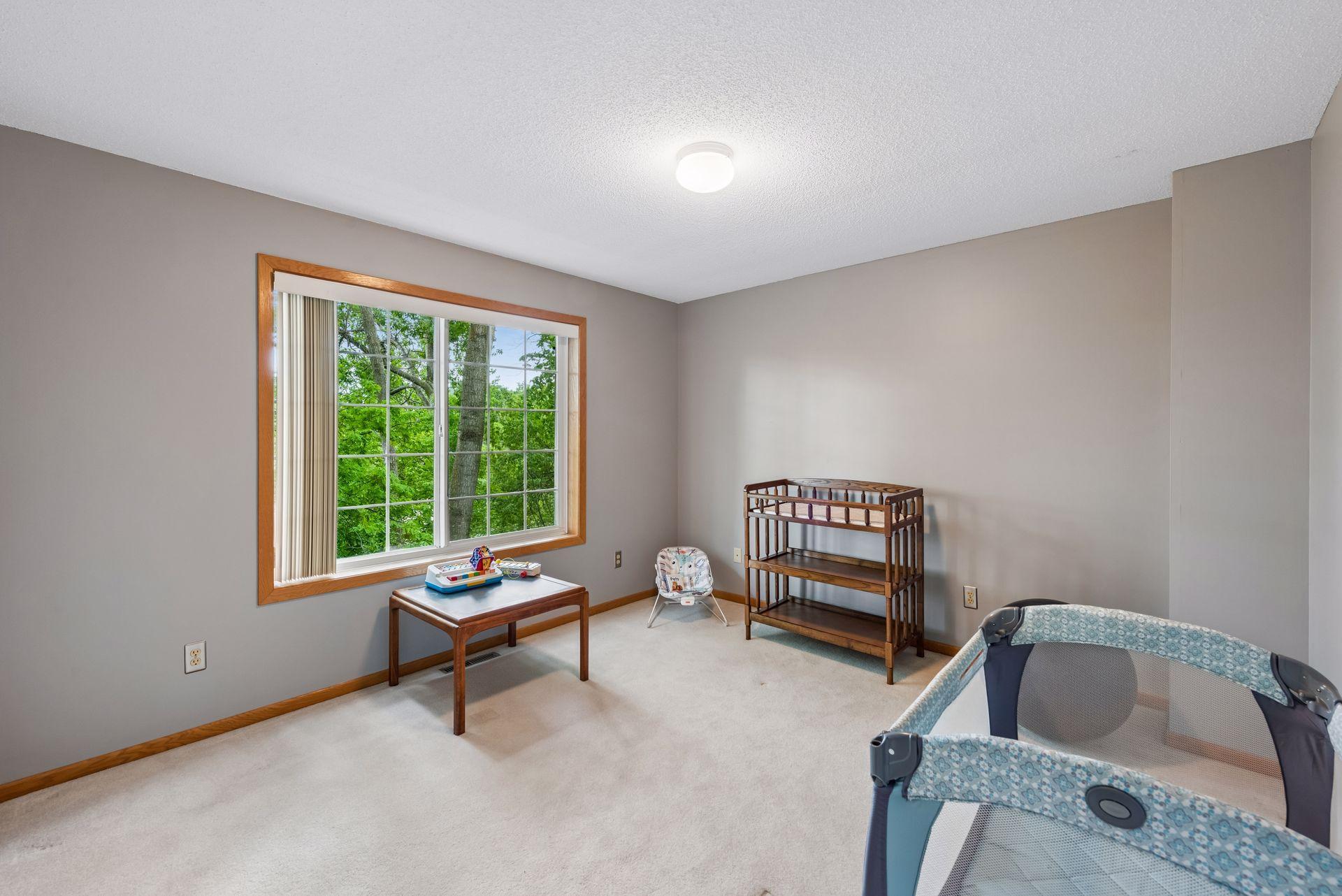 Bedroom 2 - Well-sized and have tree-topped nature views of pond.