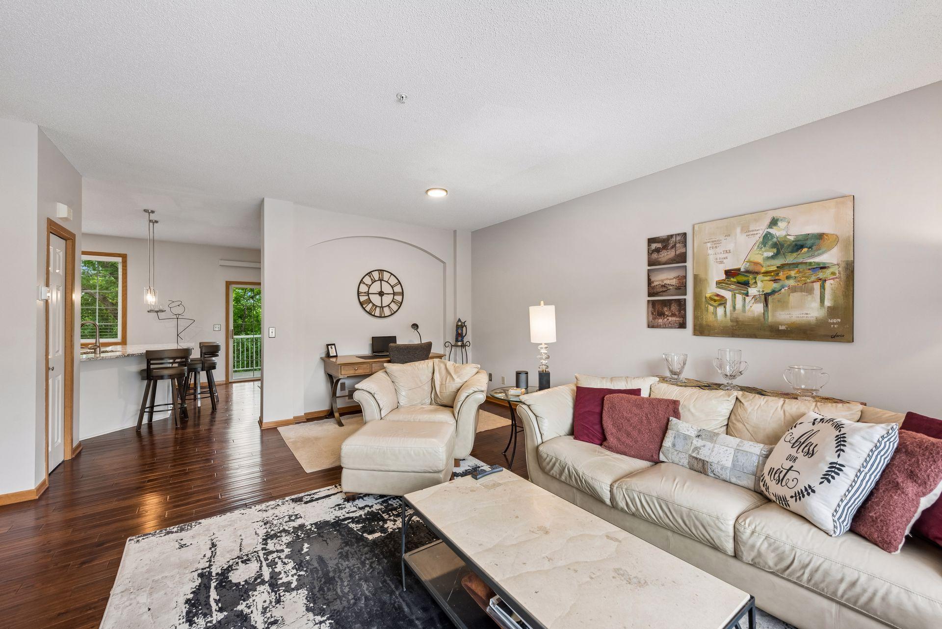The open concept main floor is updated with dark wood flooring.