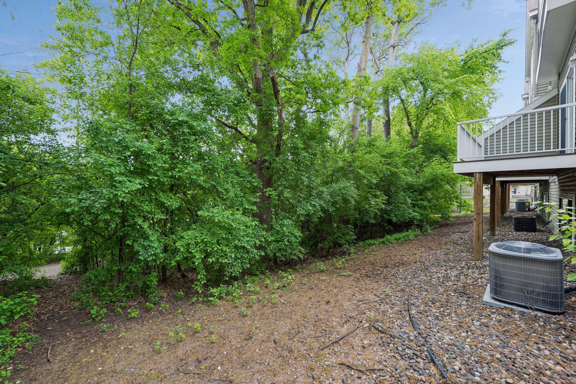 This end unit townhome backs to wooded privacy and pond with easy access to walking trail.