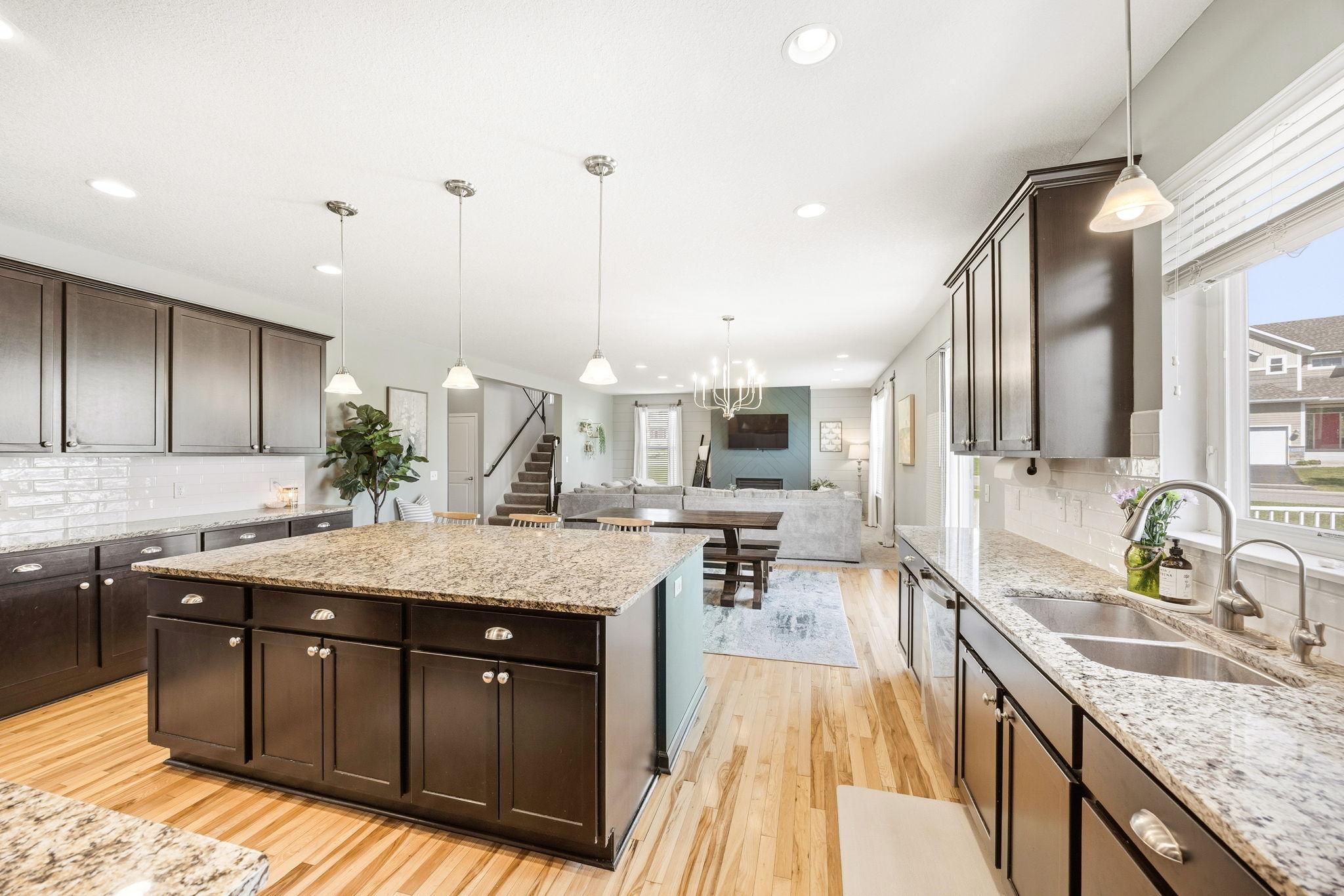 Bright and spacious open-concept layout seamlessly connects the gourmet kitchen, dining area, and living room—perfect for everyday living and entertaining alike