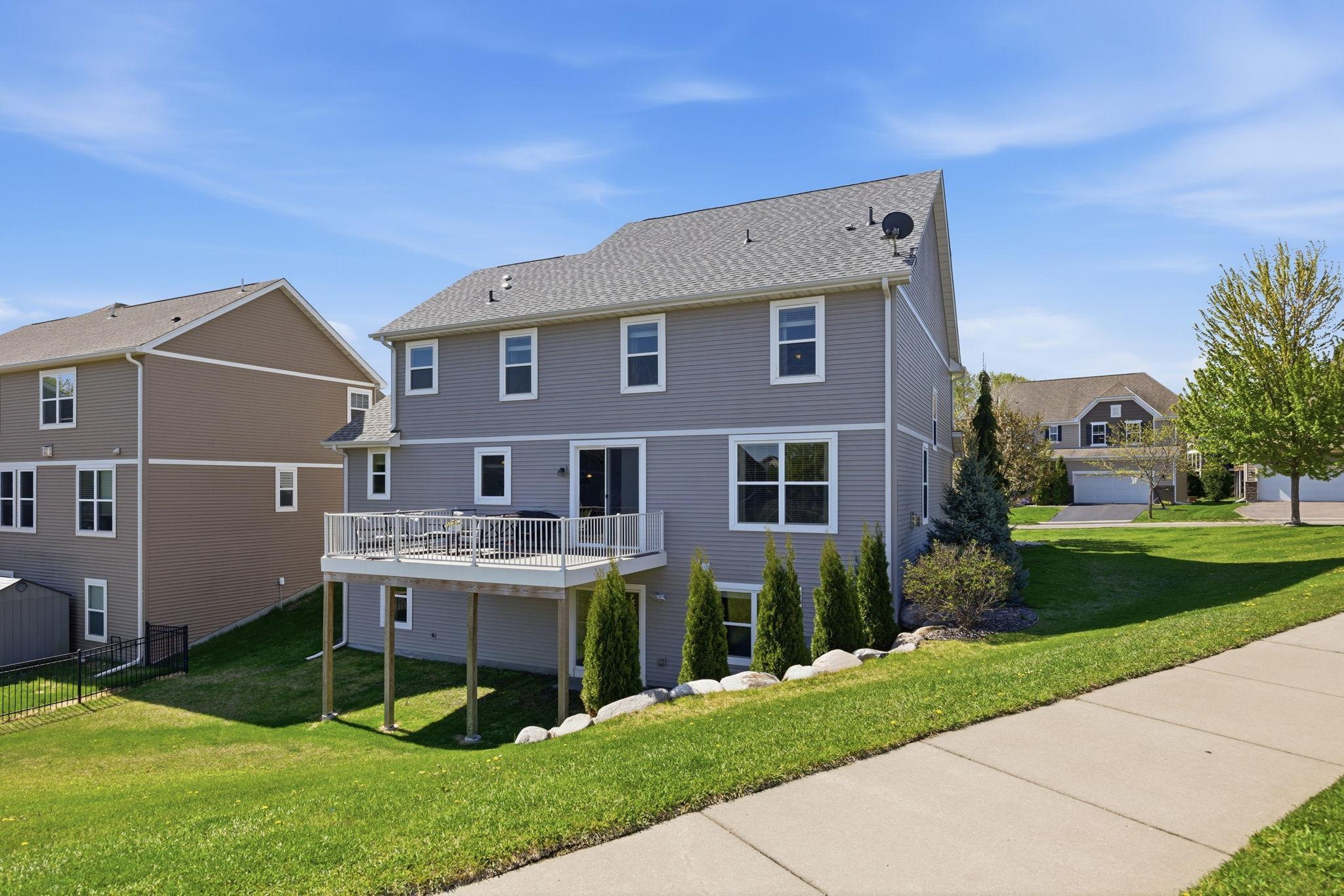 Beautiful walkout homesite with elevated maintenance-free deck, landscaped backyard, and scenic neighborhood views offering the perfect blend of privacy and outdoor enjoyment.