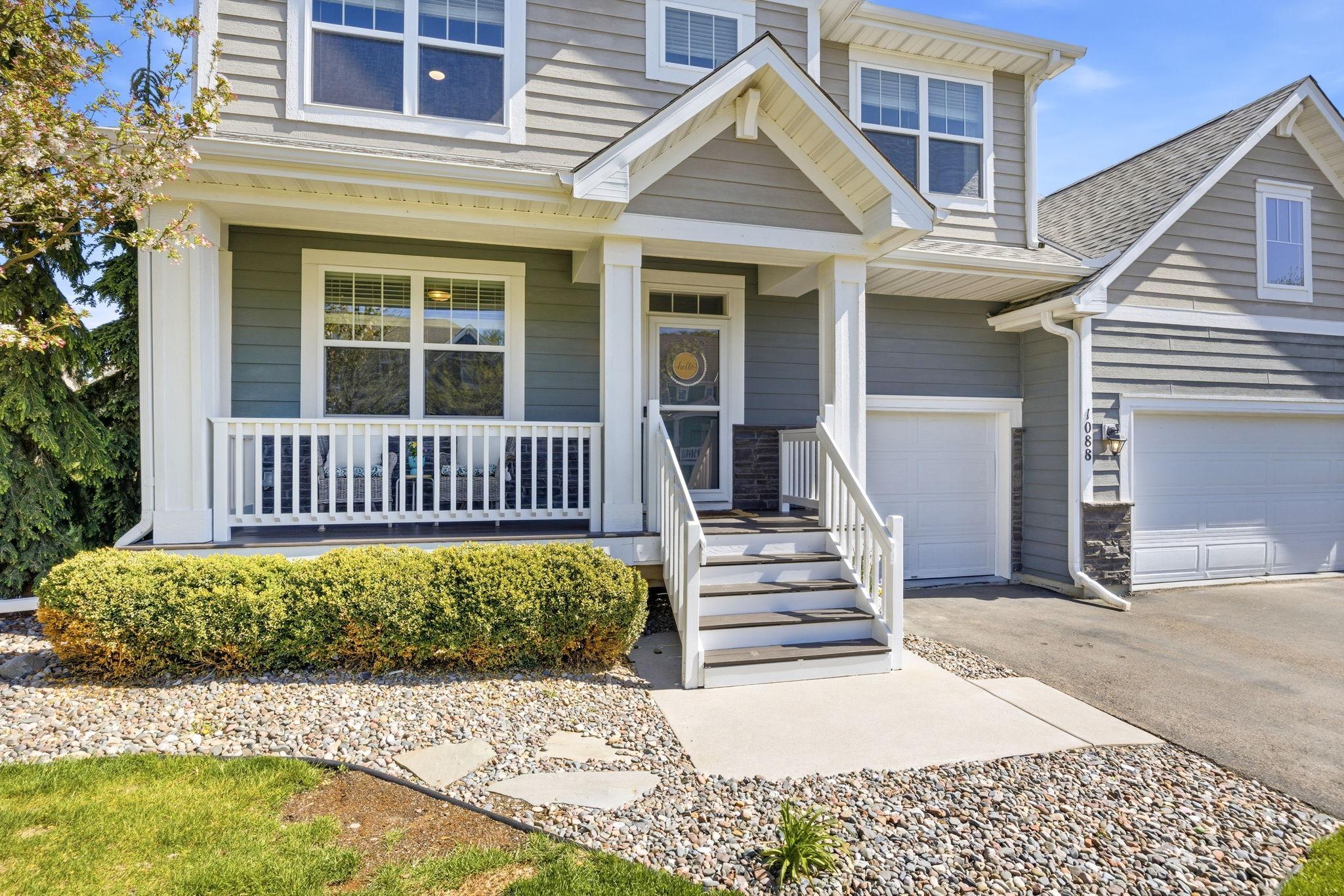 Charming covered front porch and inviting entry create the perfect welcoming first impression, accented by beautiful landscaping and timeless curb appeal