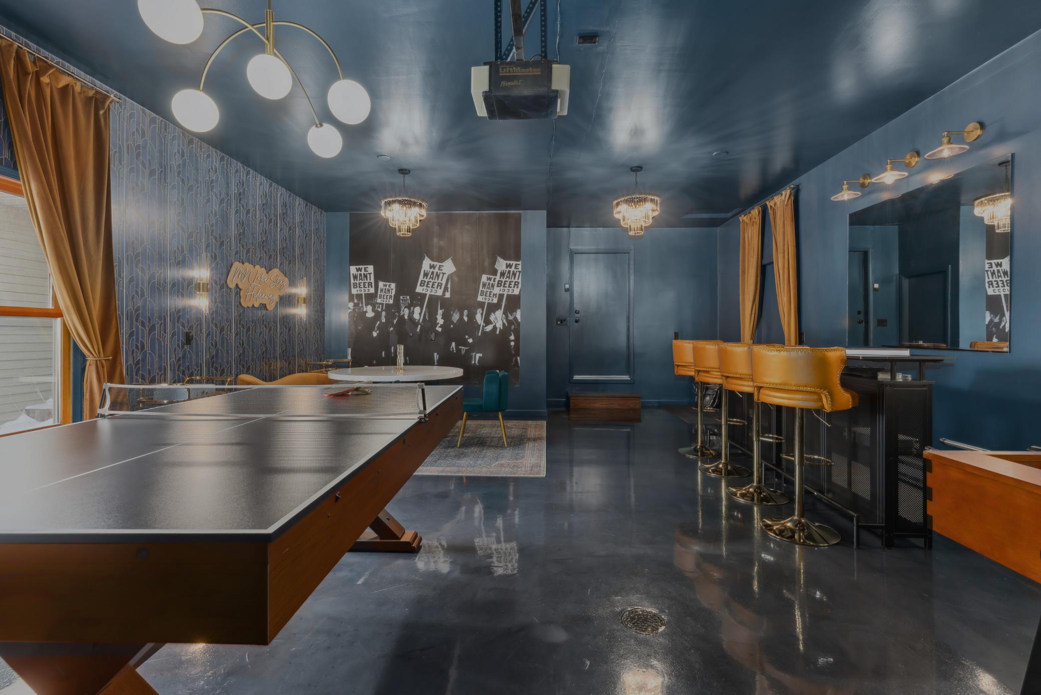 Attached 2 car garage stall, used as speakeasy theme game room. Single stall attached storage/parking