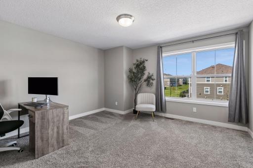 Bedroom #3 on the upper level that is spacious and filled with natural light.
