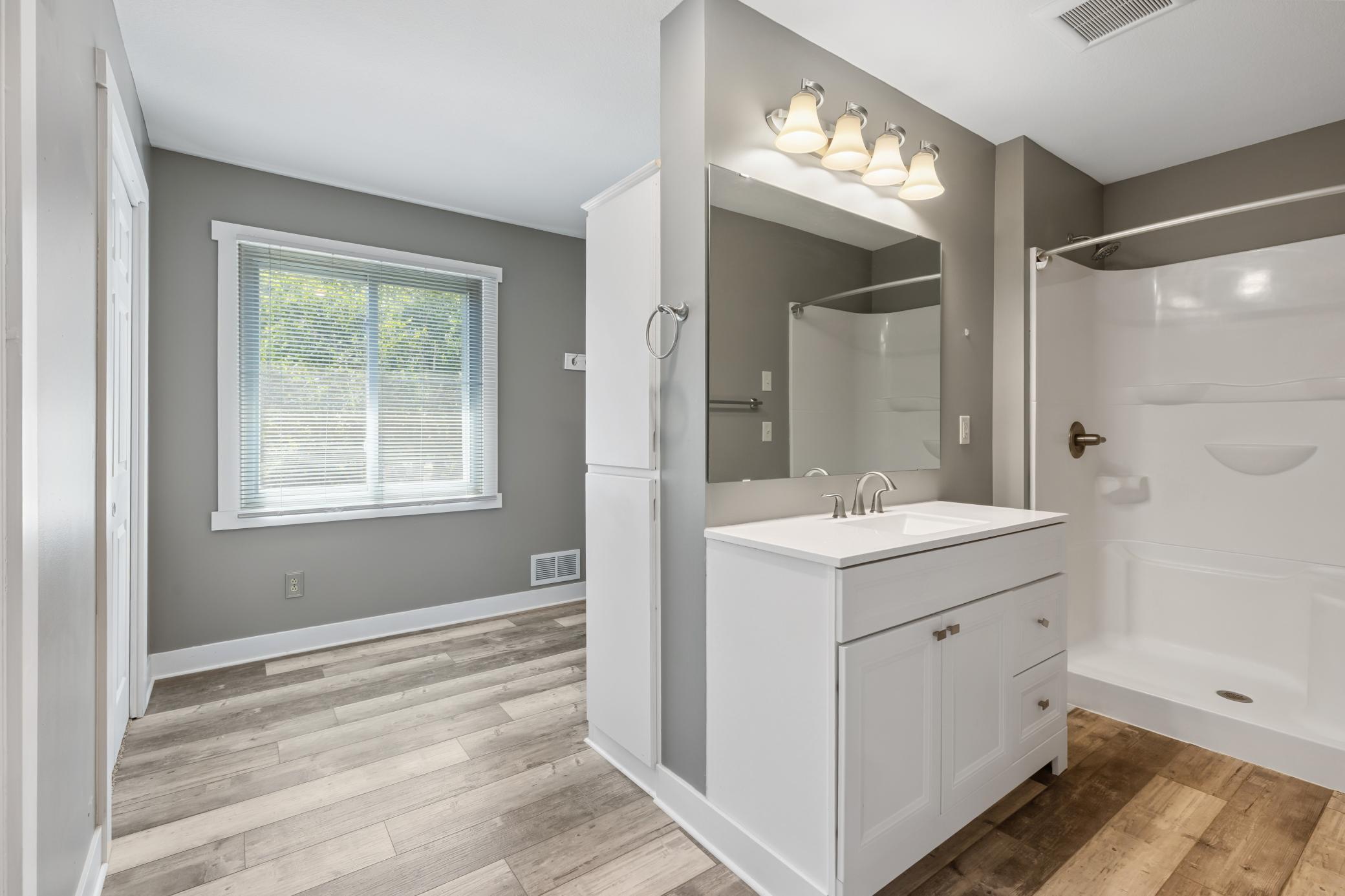 Walk-in shower w/ soaker tub on other side of wall