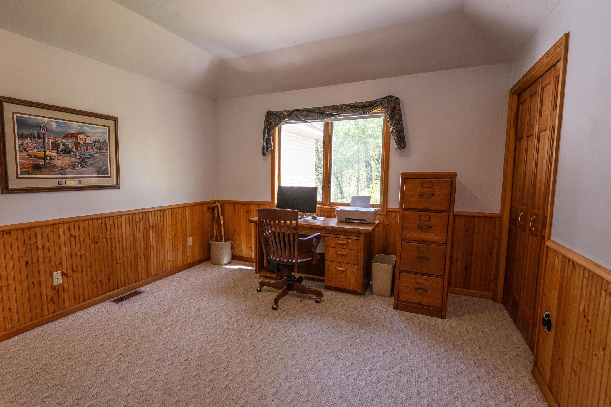 This is the fourth bedroom which is currently being used as a Home Office. This is right off the family room and across the hall from a three quarter bathroom. You could use this as a primary bedroom and have all living on one level