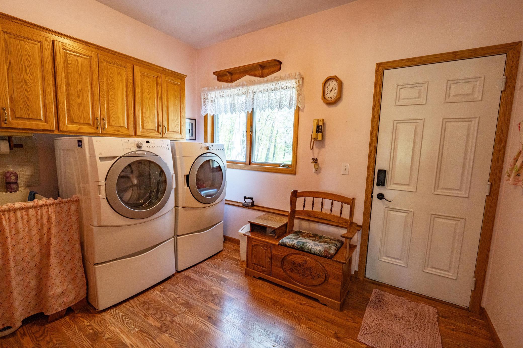 Main level laundry room has its own entrance to the exterior of the home and to the right that's not in the photo is the door to the attached garage. Laundry room includes appliances and sink