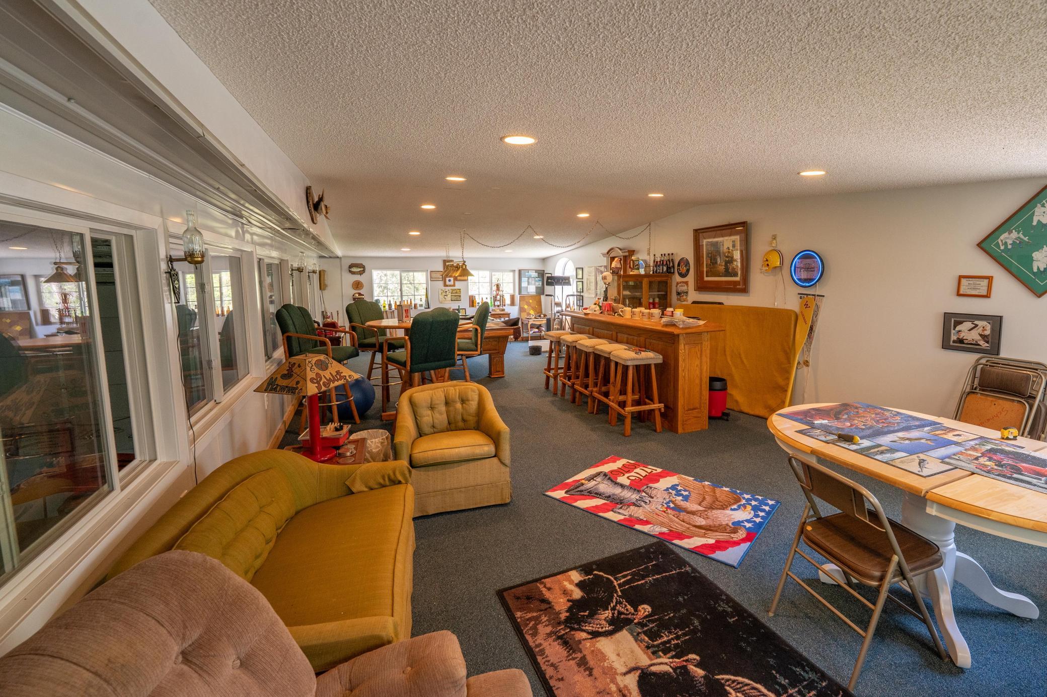 The shed is divided into several areas. This is the upper recreation room. Below this that's equal size and insulated is an office which looks similar to this. On the backside, there is a workshop and above that storage.