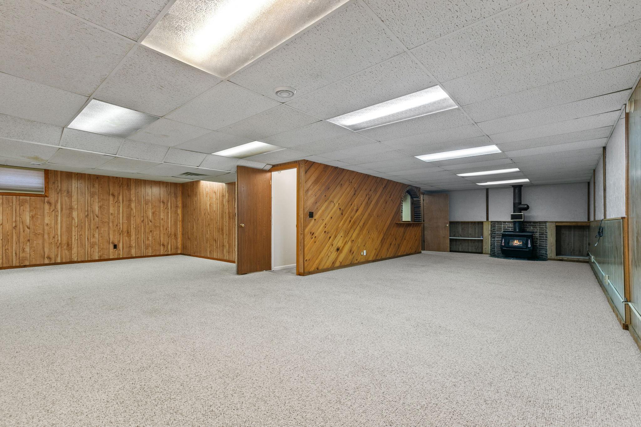Huge lower level with wood burning stove.