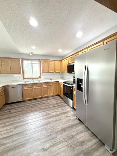 Kitchen with Ample Cabinet Storage and Brand New Stainless Steel Appliances