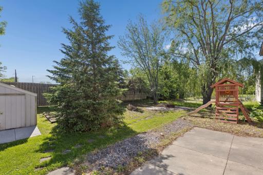 Generous Backyard and Cement Patio and Stamped Concrete Firepit Area