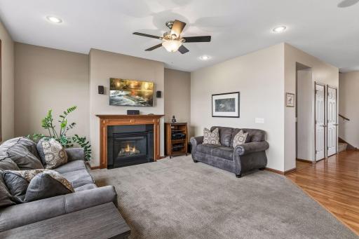 This is a bright room with a large bank of windows, recessed lighting and a ceiling fan with light kit.