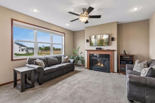 The focal point of the living room is the gas fireplace. Seller will be leaving the TV, mount, speakers and receiver.