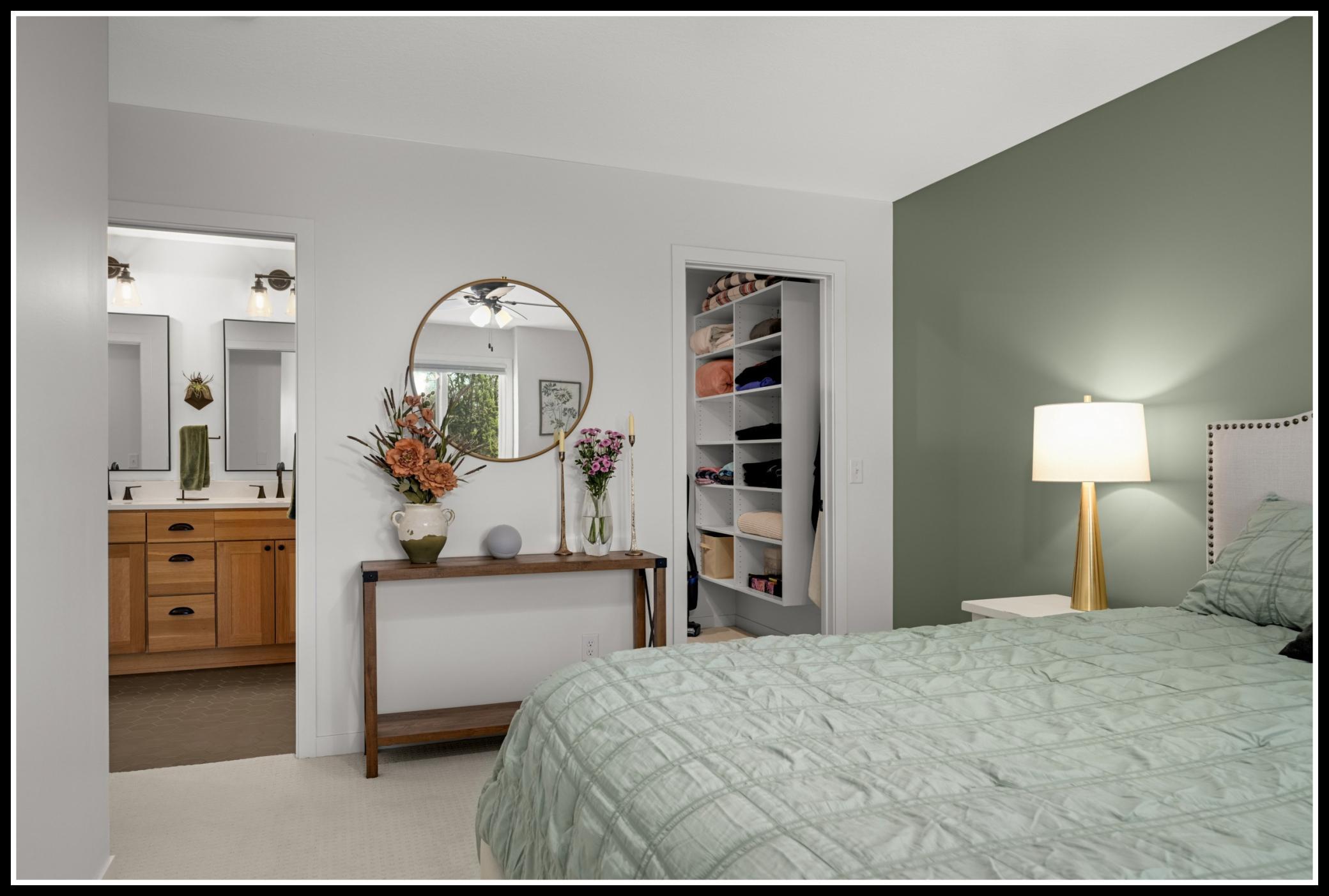 Huge walk-in closet with custom built-ins and walk-through access to the upper level bathroom