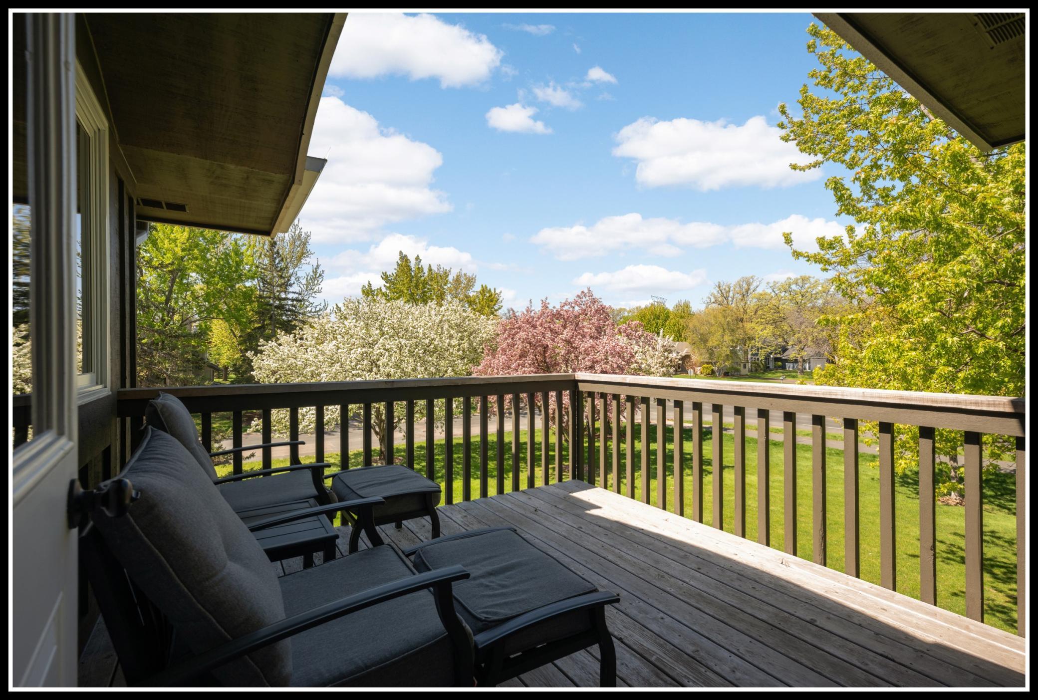 Large, wood deck off of the sunroom has lots of space for outdoor seating