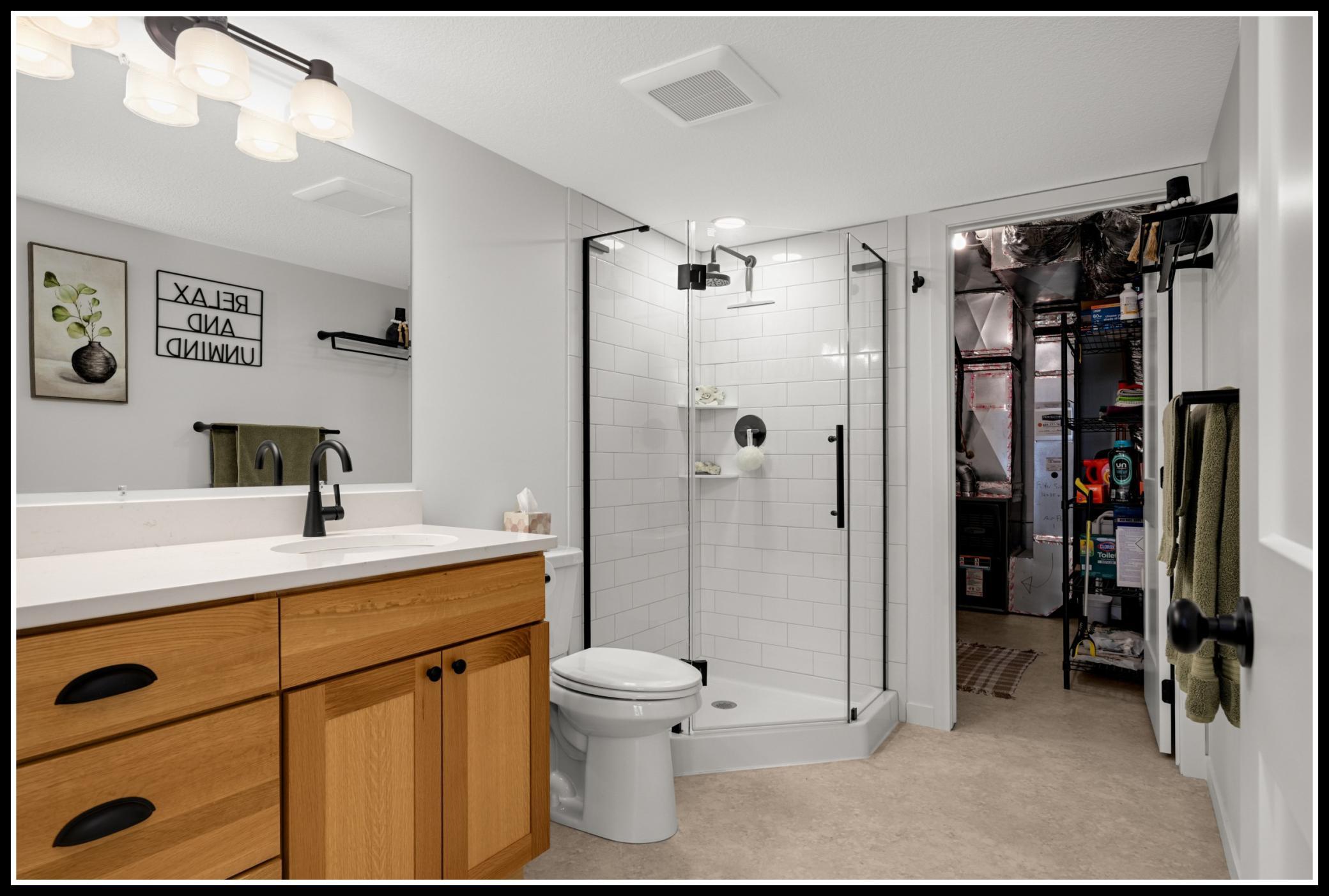 Laundry and mechanics are concealed behind the three-quarter bathroom
