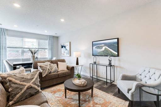 Large living room with electric fireplace (not shown). Model photo. Options and colors will vary.