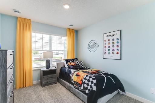Spacious 2nd bedroom on upper level. Model photos. Options and colors will vary.