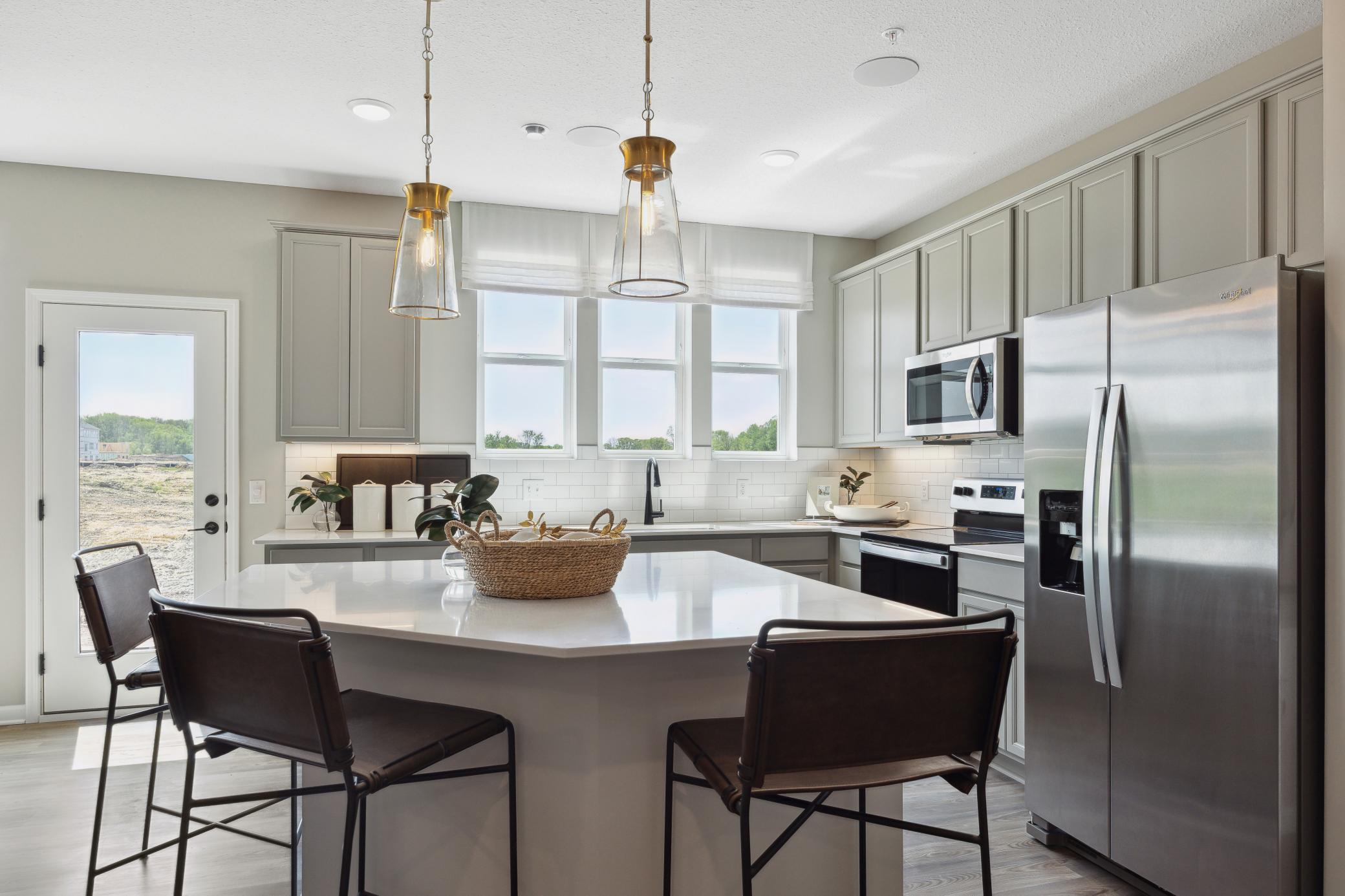 Gorgeously designed center island with sink overlooking the back