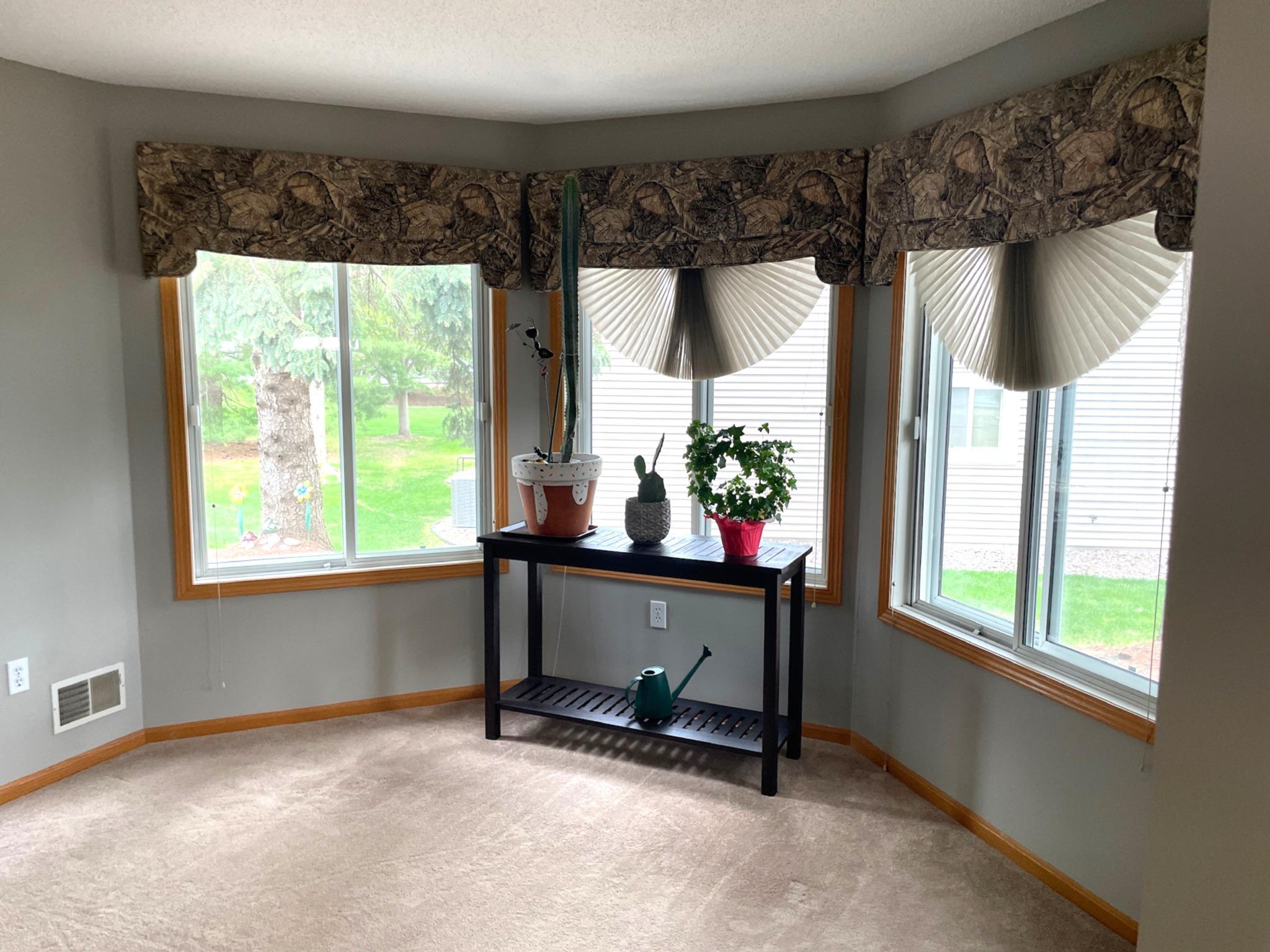 Custom blinds and window treatments in sunroom and throughout unit