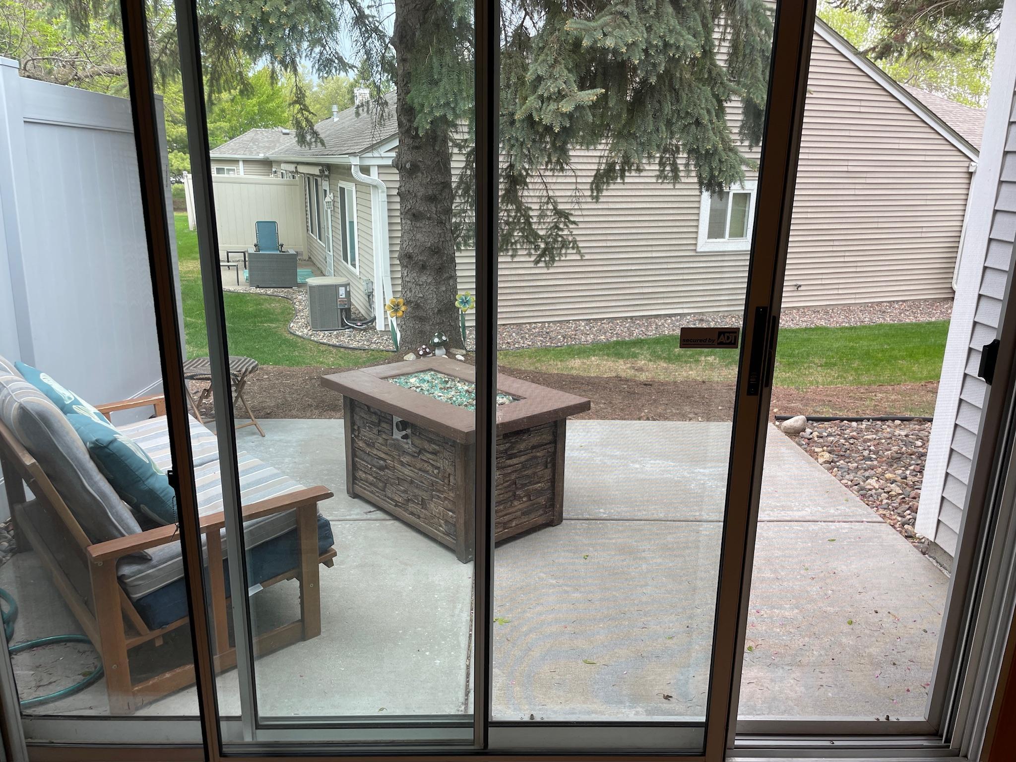 Triple sliding door to "nestled" patio.