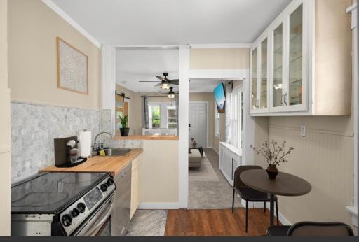 This bright kitchen has a dishwasher, range, updated stainless steel appliances, water & ice, LVP flooring! The bright space has two kitchen windows, opens into the living room from the cute back porch!