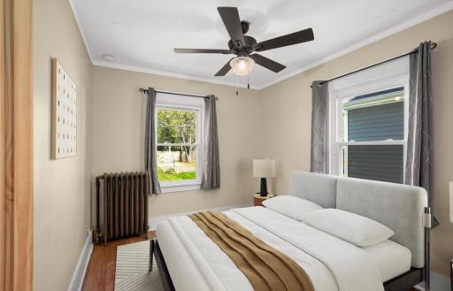 Virtually staged photos always give buyers a window into ideas as to what they can do with spaces in a home! This is the back bedroom on main.