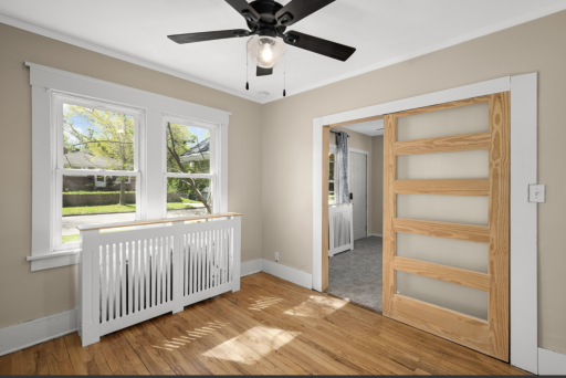 The home has a boiler and radiators for heat. The are tastefully placed for even heat throughout the home! This photo is from the front bedroom looking out into the LR.