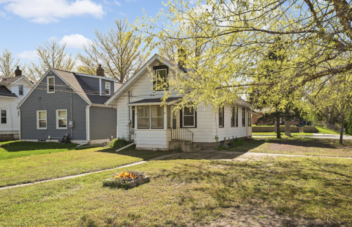 This home has a great flat yard with a couple beautiful trees! It has cement footing in areas of the yard where there used to be a fence.