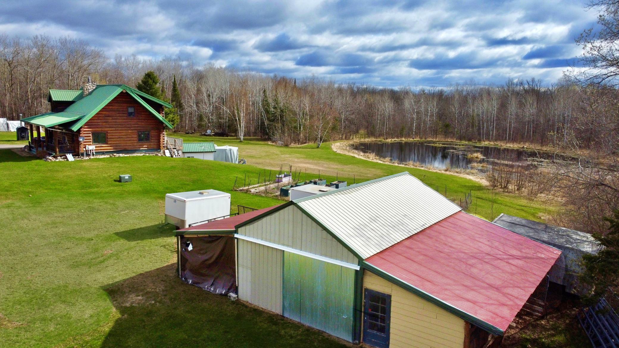 Aerial view of property with pond and outbuilding.jpg