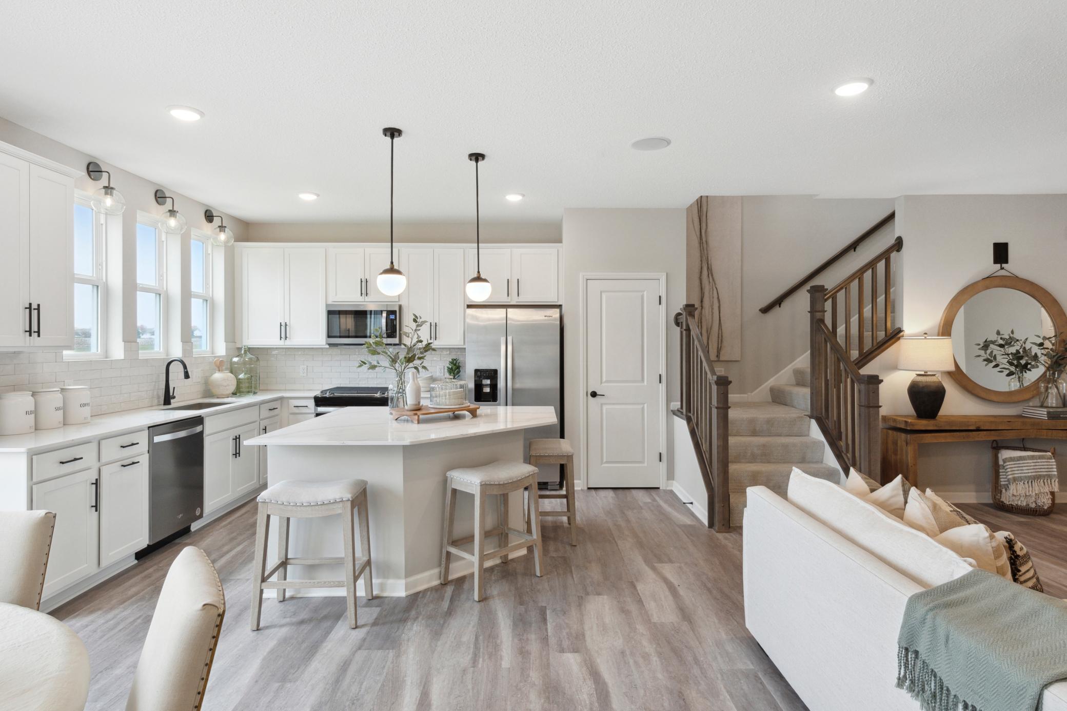 A truly one-of-a-kind kitchen island is the center piece of this kitchen. Equally beautiful and functional. This island is sure to impress while allowing for any undertaking in the kitchen! Photo of model home.