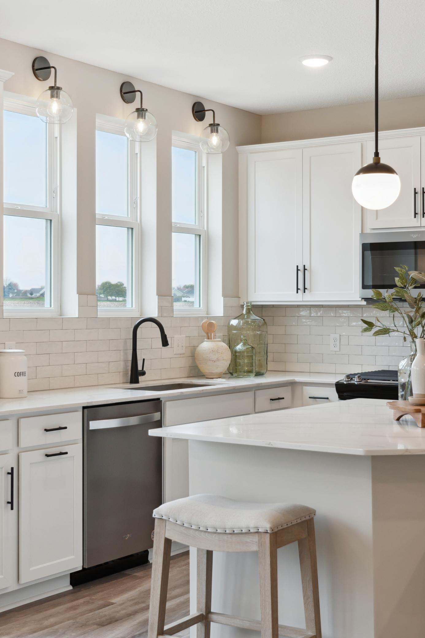 Kitchen comes with modern stainless steel appliances providing both functionality and style. Photo of model home.
