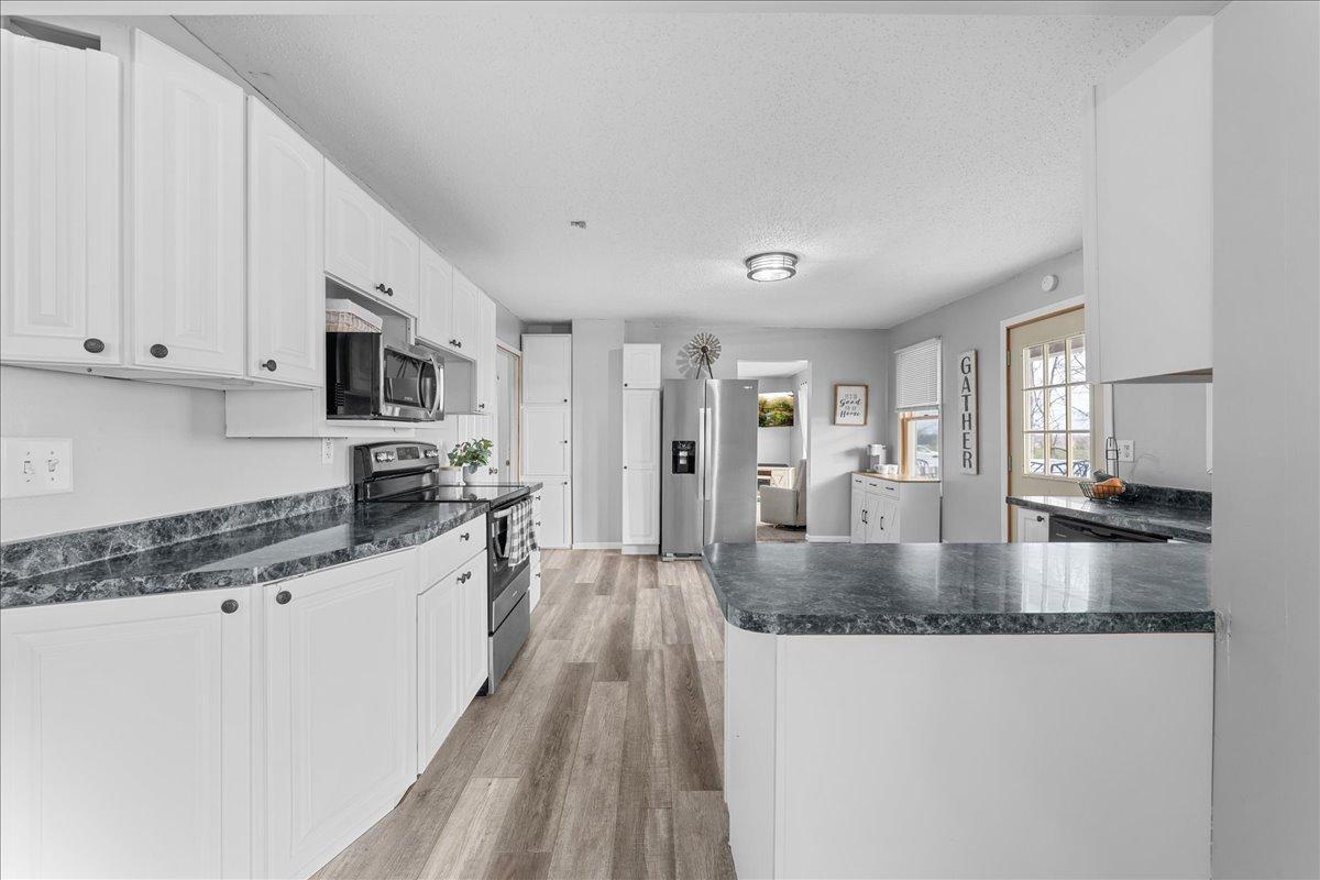 Inviting open kitchen with stainless appliances.jpg