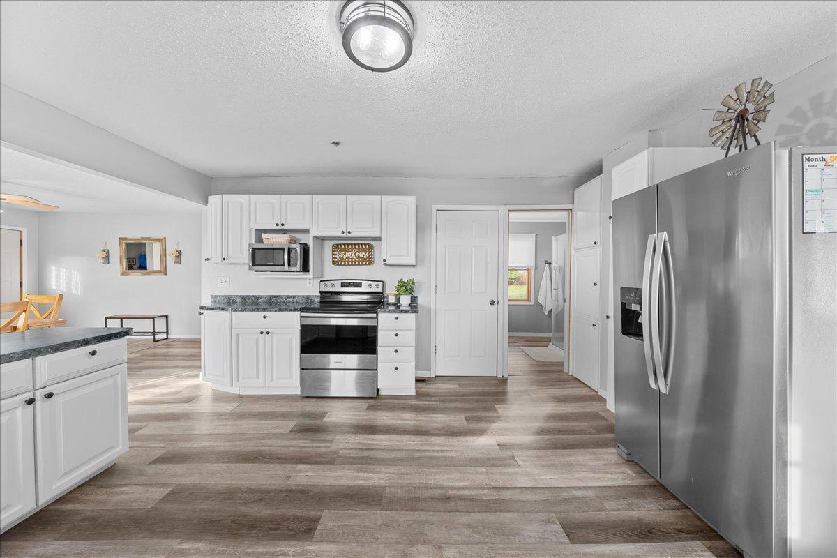 The spacious farmhouse kitchen offers plenty of counter space and room to bake homemade sourdough, gather with family, and enjoy country living at its best.jpg