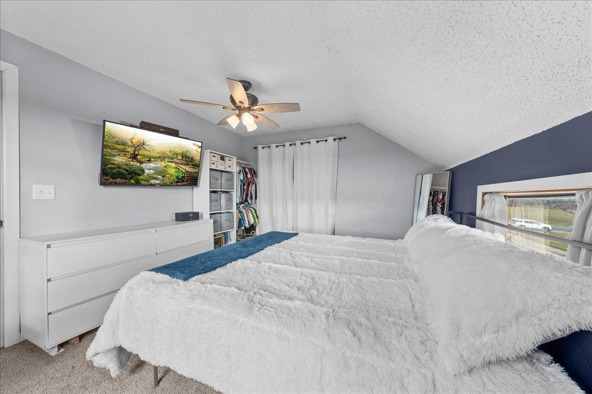 Spacious upstairs primary bedroom offering a peaceful retreat with comfort, privacy, and restful farmhouse charm.jpg