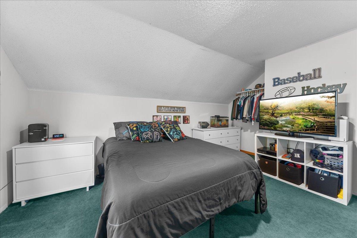 Upstairs bedroom offering generous space, natural light, and a comfortable layout ideal for guests or family.jpg
