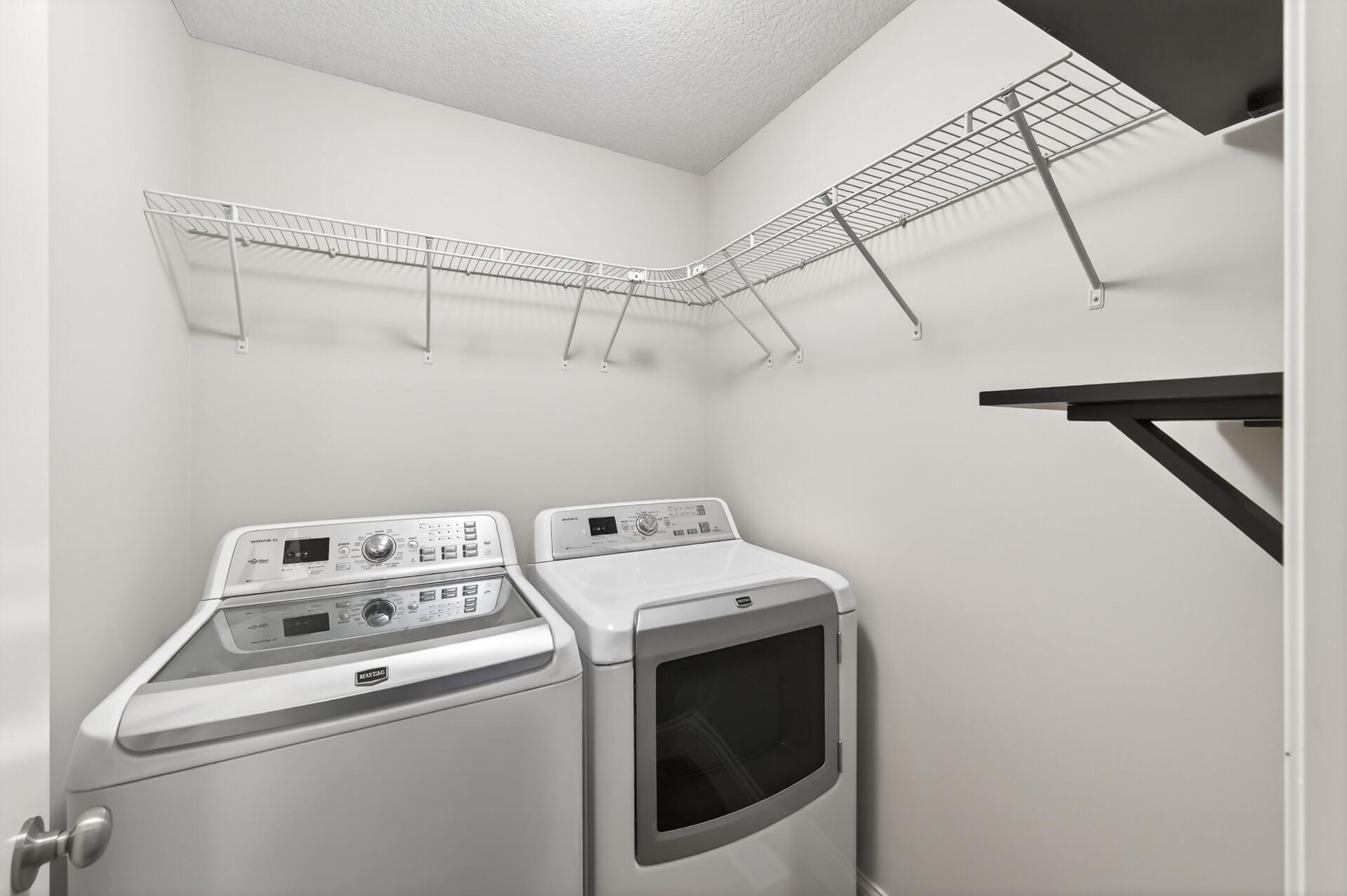 Upper Level Laundry with shelving.