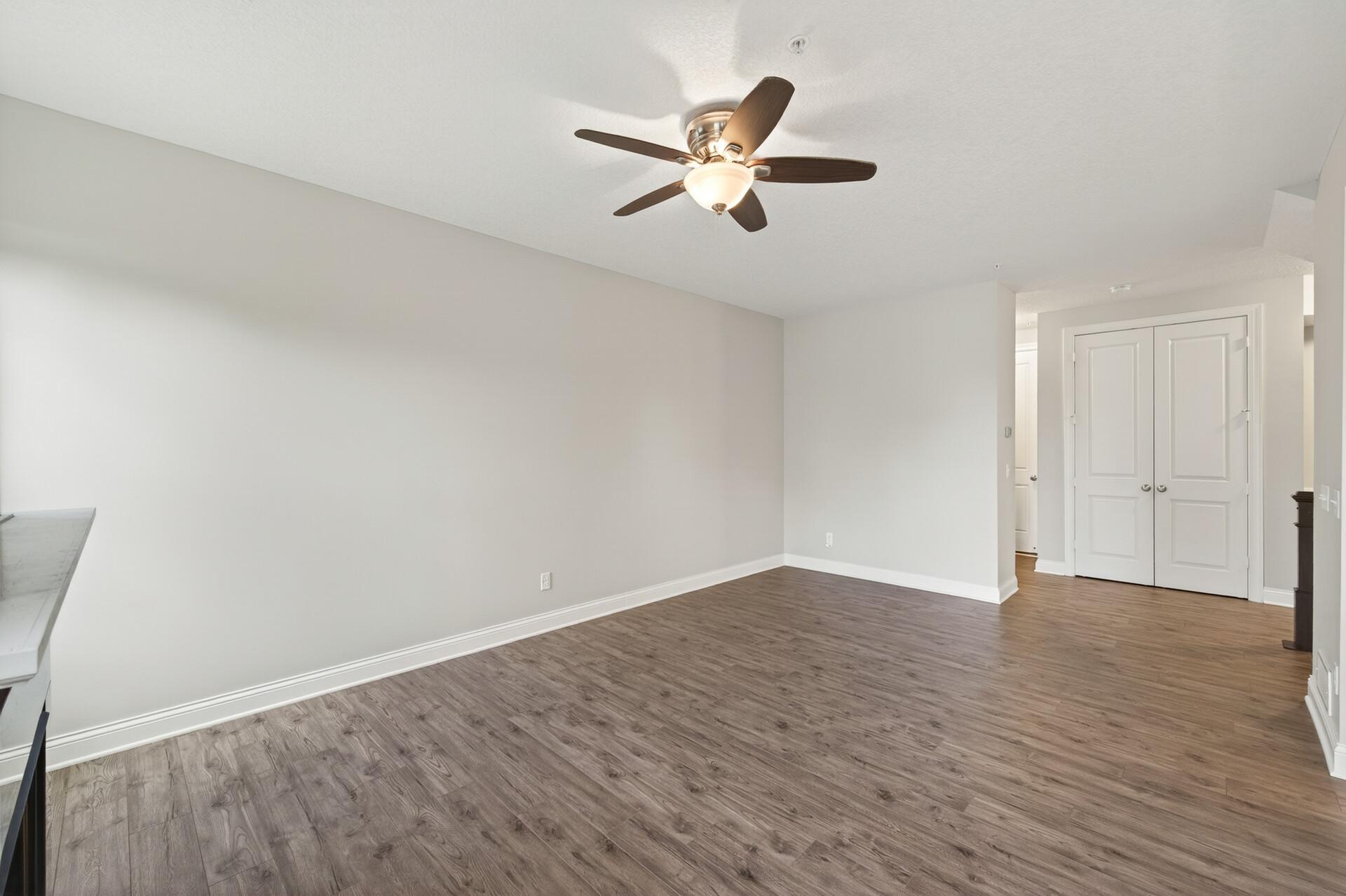 Spacious living room with ceiling fan.