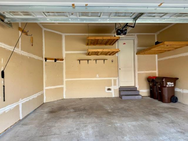 Garage with large attached shelving & organizers.