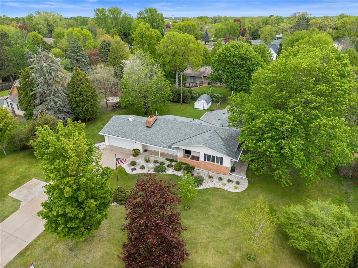 Mature landscaping and towering trees give the property a timeless, established feel.