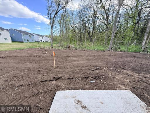 Final graded area will have irrigation and sod - the trees beyond are also on the lot - see supplements for exact dimensions/lot survey