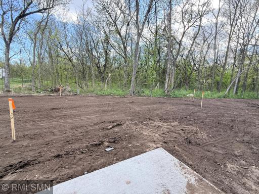 Final graded area will have irrigation and sod - the trees beyond are also on the lot - see supplements for exact dimensions/lot survey