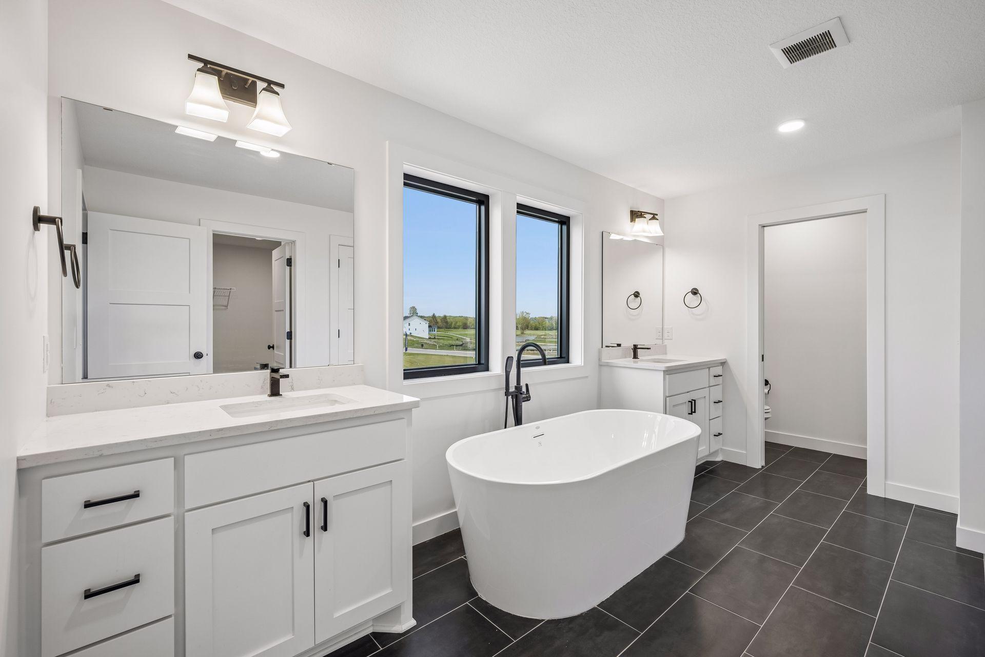Private primary bathroom with dual sinks, soaking tub and walk-in shower