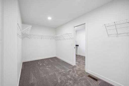 Walk-through primary closet to laundry room