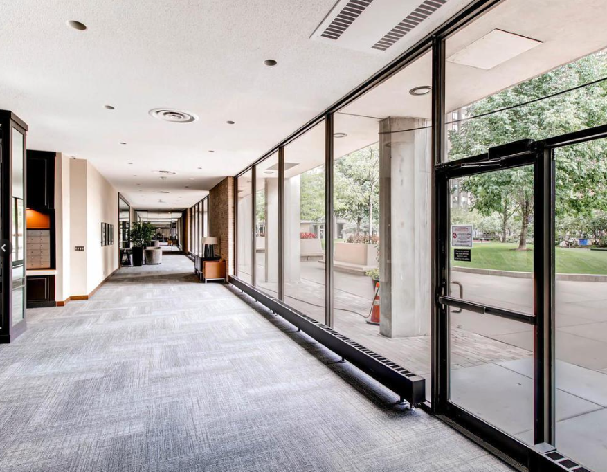 Almost 2 block long well lit secure lobby hallway. Has several seating areas. Floor to ceiling windows. Perfect walking in winter..png